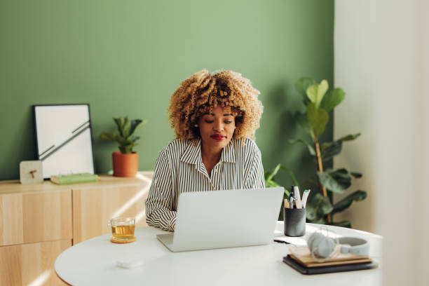 istock Happy Businesswoman Working on her Laptop Computer 1387035309