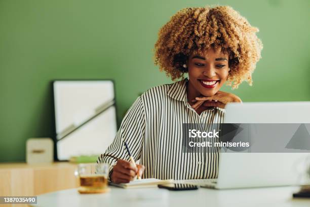 Happy Businesswoman Working At Her Office Stock Photo - Download Image Now - People, Women, One Woman Only