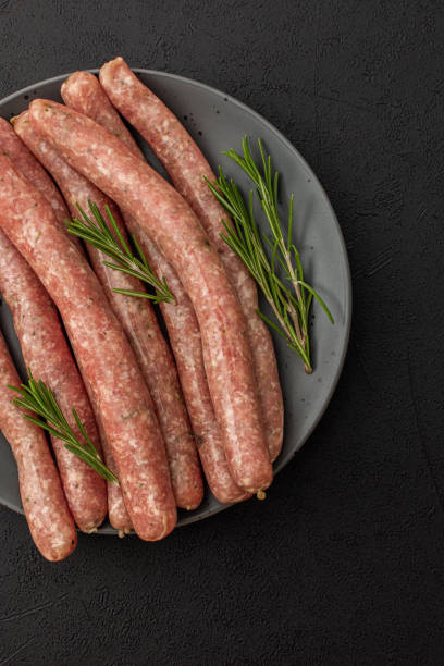 istock Raw pork sausages with rosemary 1387037476