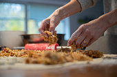 Low angle view of a woman making traditional homemade apple strudel