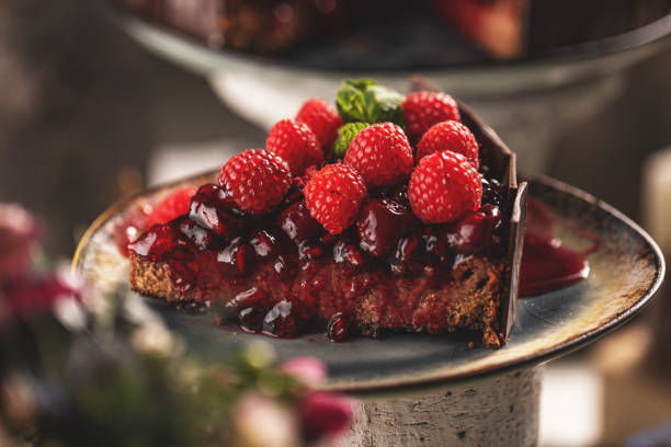 istock Slice of chocolate cake with cherry sauce 1387038700