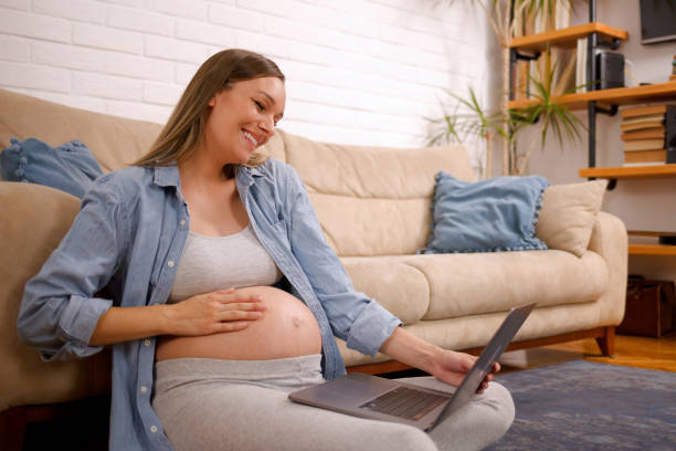 istock Pregnant woman making a video call from home 1387039263