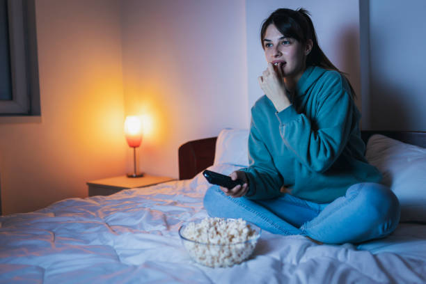 istock Woman relaxing at home watching TV 1387040615