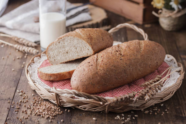 istock bread and wheat on wooden table 1387042798