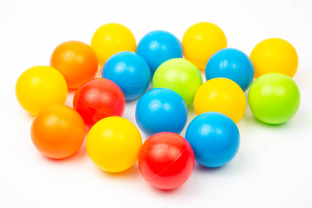 istock Colored plastic balls on white background. leisure and game items. round objects 1387042925