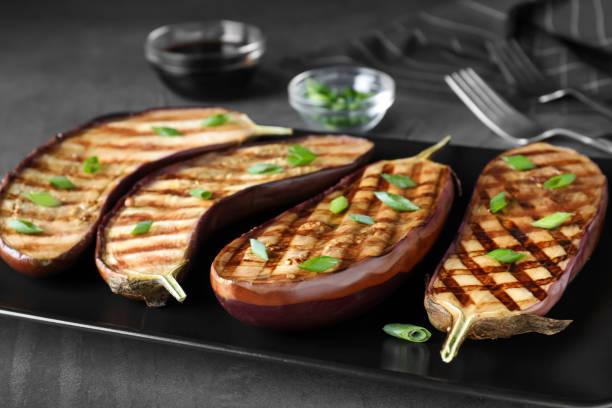 istock Delicious grilled eggplant halves served on plate, closeup 1387044935