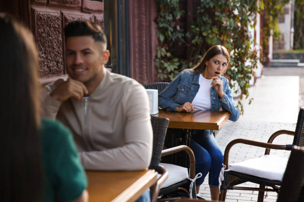 jealous ex girlfriend spying on couple in outdoor cafe - former imagens e fotografias de stock