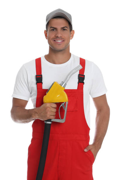 istock Gas station worker with fuel nozzle on white background 1387047467