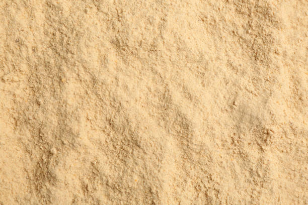 istock Dry powdered ginger as background, top view 1387047561