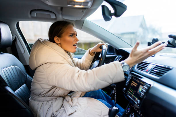 istock Angry woman driver scream stuck in traffic jam 1387048417