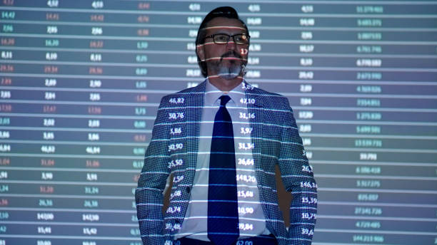 istock Financial data projection on a mature businessman 1387048533