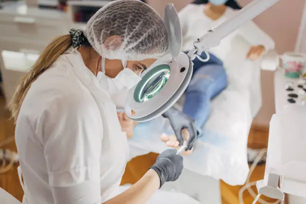 Photo of Beautician working in nail salon