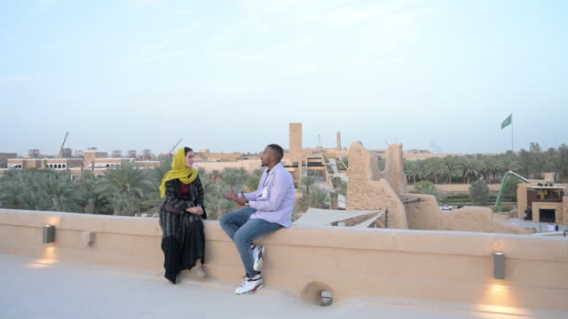 Tourists relaxing and talking at open air museum near Riyadh