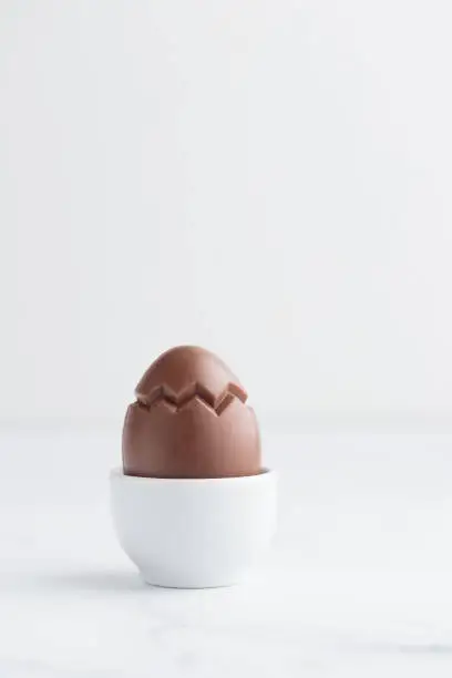 Chocolate easter egg in a white eggholder