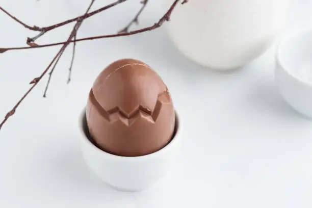 Chocolate easter egg in a white eggholder