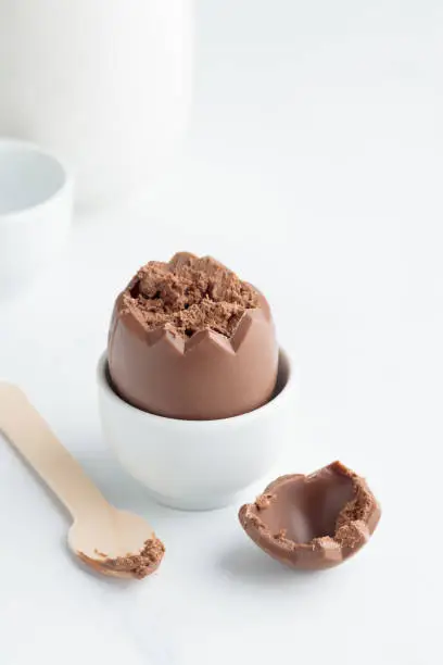 Chocolate easter egg in a white eggholder