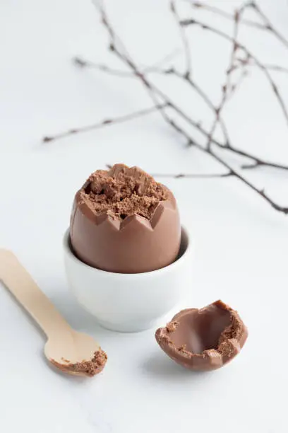 Chocolate easter egg in a white eggholder