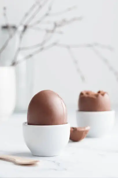 Chocolate easter egg in a white eggholder