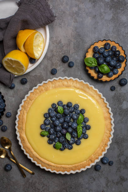 istock Blueberry and lemon curd tart on dark grey stone table. Top view. Vertical image. 1387051163