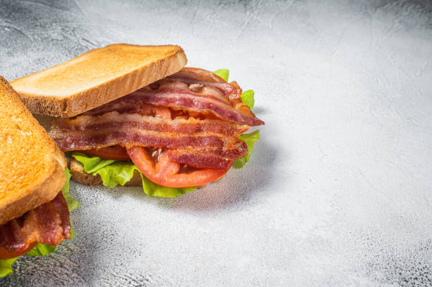 istock BLT toasted sandwich with bacon, tomato and lettuce. Gray background. Top view. Copy space 1387051785