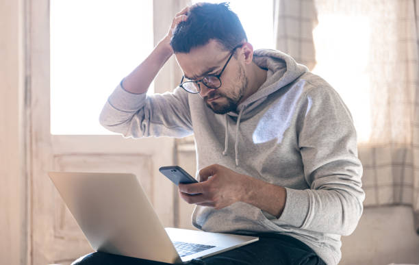 istock A man with glasses is working on a laptop. 1387052491