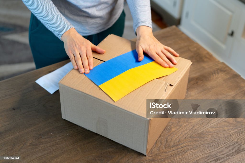 An unrecognisable person is closing a donation box . Help for people in need in Ukraine An unrecognisable person is preparing a grocery box for people in need in Ukraine Ukraine Stock Photo