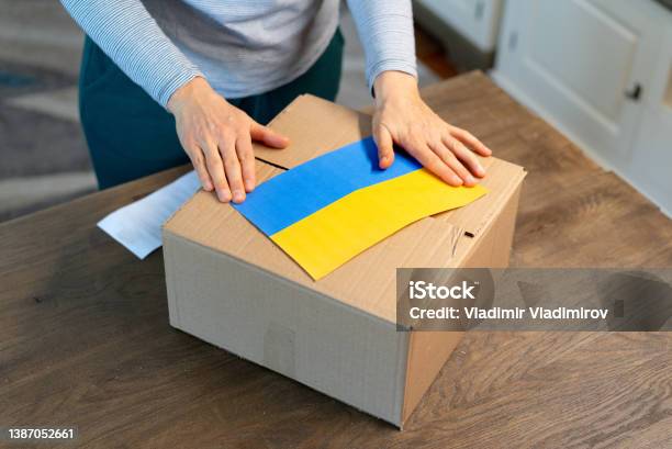 An Unrecognisable Person Is Closing A Donation Box Help For People In Need In Ukraine Stock Photo - Download Image Now
