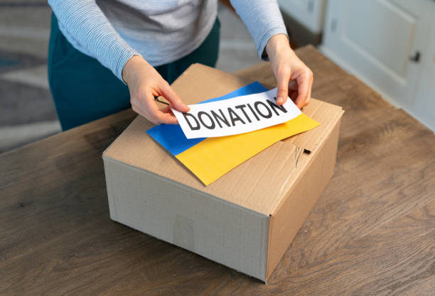 istock An unrecognisable person is closing a donation box . Help for people in need in Ukraine 1387052662