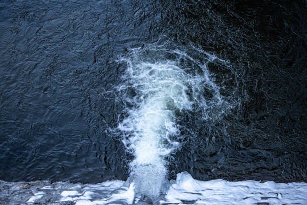 Natural waterfall, top view, water texture and foaming waves, natural background.