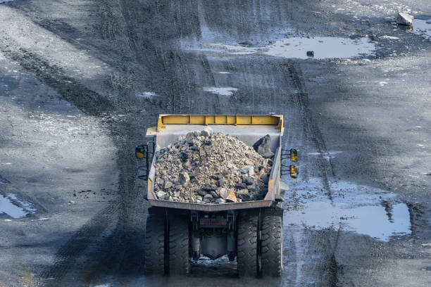 istock Dump truck in limestone mining, heavy machinery. Mining in the quarry. 1387059237