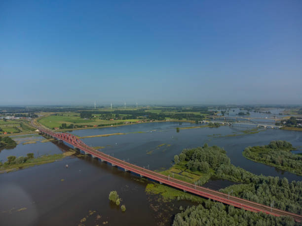 istock Hanzeboog train bridge with high water level on the floodplains 1387059590