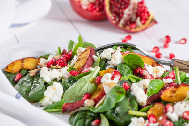istock Salad. Spring vegetable salad. Fresh vegetable salad with grilled peach, pomegranate, spinach and fresh cheese. 1387060747