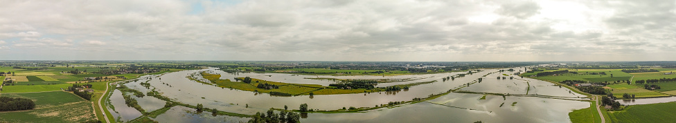 High water level on the floodplains of the river IJssel between Zwolle and Deventer on July 20 in Zwolle, Overijssel, The Netherlands. Aerial drone point of view over the river and overflown fields after heavy rainfall upstream in Germany.