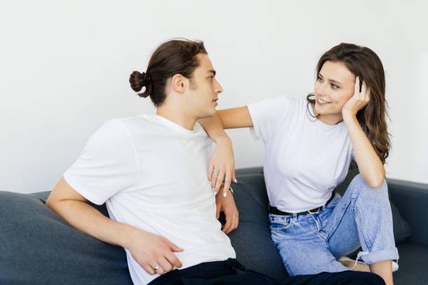 istock Young Couple at home relaxing in sofa 1387061503