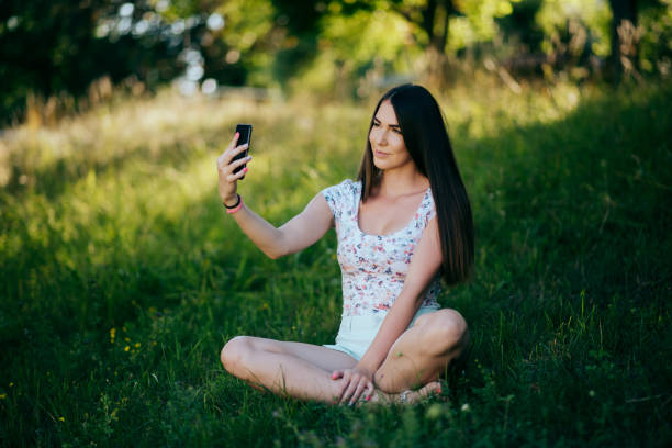 istock Girl taking selfie in the park 1387062306