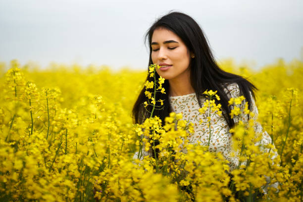 istock Hispanic woman in a canola field 1387064176