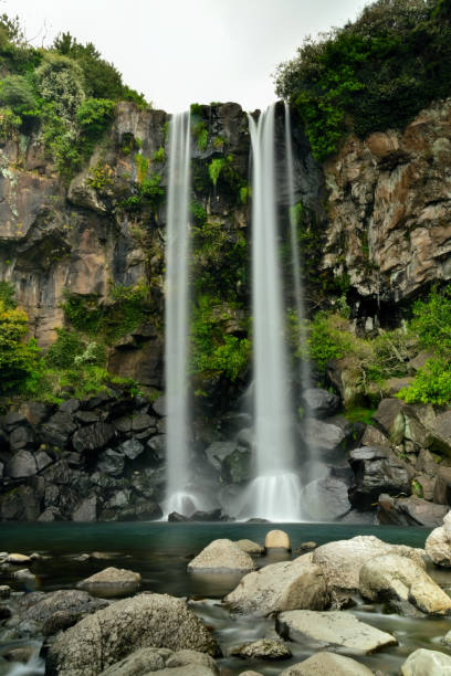 istock Jungbang waterfall falling into the sea 1387065687