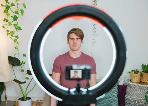 istock Teaching meditation on live streaming video on digital camera 1387065805