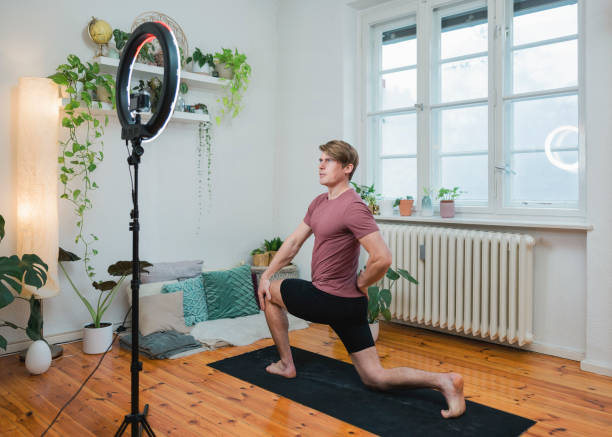 istock Yoga teacher live streaming exercises at home 1387065808