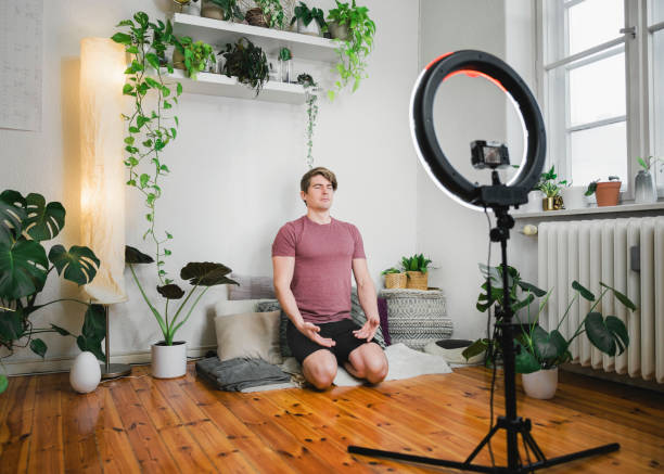 istock Young man recording yoga tutorial video for fitness his vlog 1387065821
