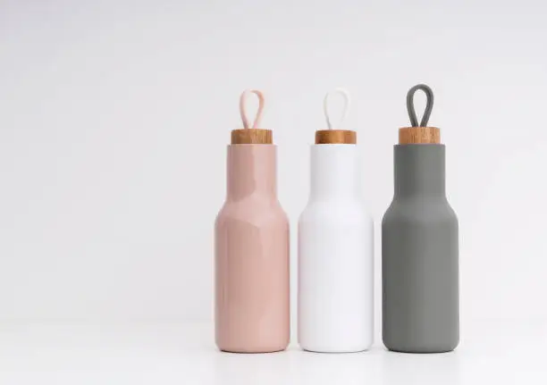 Photo of Modern water bottles on white background