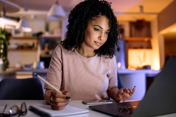 istock Young beautiful woman studying from her apartment 1387067257