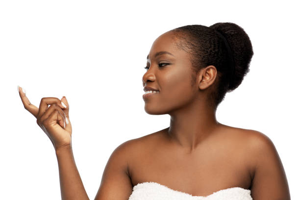 istock smiling african american woman with moisturizer 1387068527