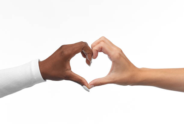 istock black and white hands making heart gesture 1387069233