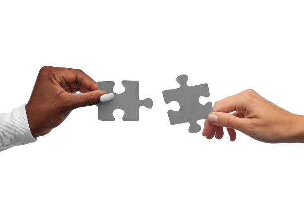 istock black and white hands matching pieces of puzzle 1387069645