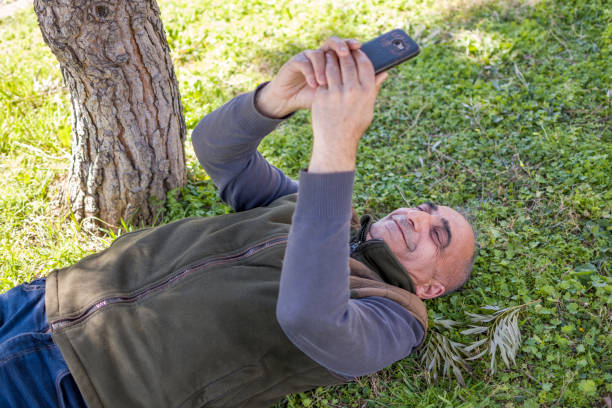 istock Handsome man using mobile phone outdoors 1387069850