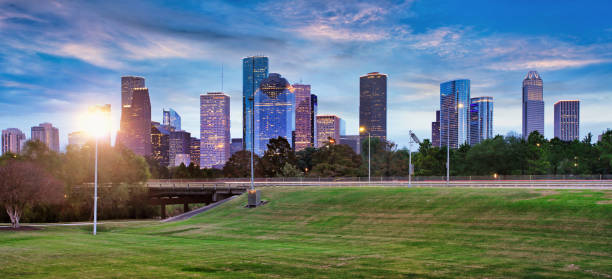 istock Houston Texas modern skyline at sunset twilight from park lawn 1387069953