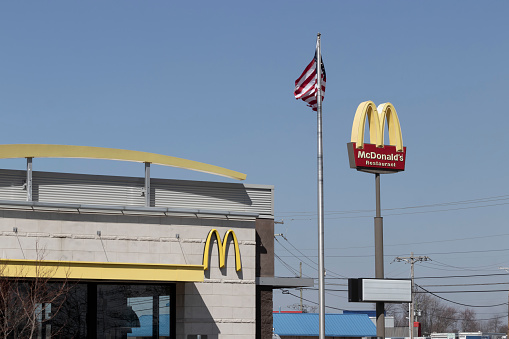 Brownsburg - Circa March 2022: McDonald's Restaurant. McDonald's is offering employees higher hourly wages, paid time off, backup child care and tuition payments.