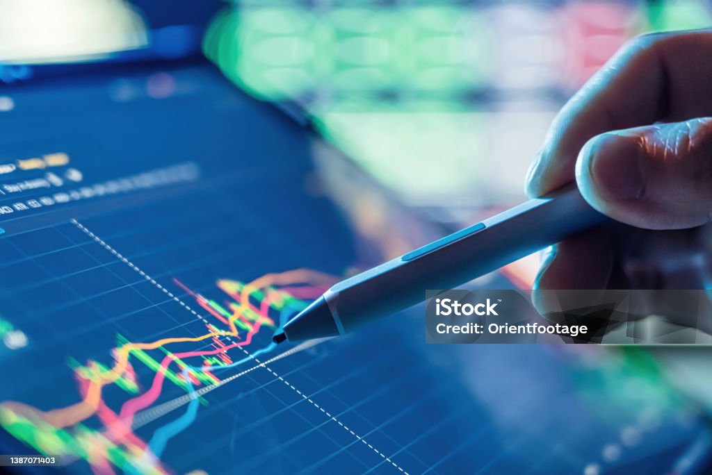Businessman use tablet and smart phone for Stock Market Investment Stock Photo