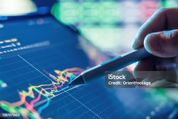 Businessman Use Tablet And Smart Phone For Stock Market Stock Photo - Download Image Now